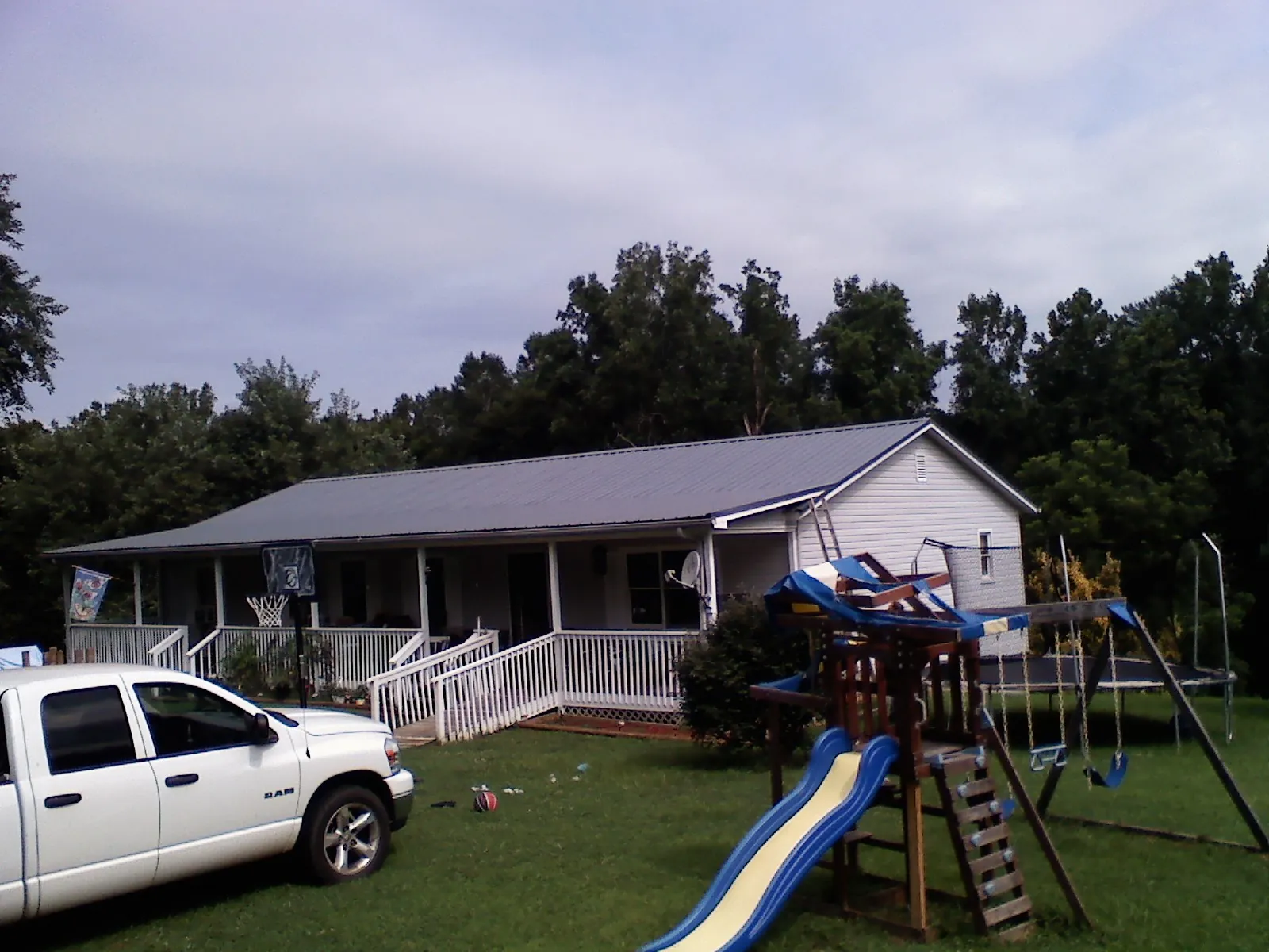 Dark metal roof on a country home with a full length front porch in Luke Air Force Base
